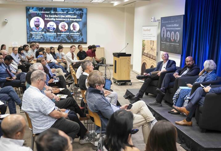 Audience members listening to a panel discussion.