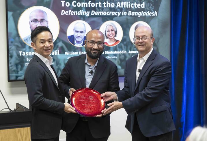 Kiyoteru Tsutsui and James Hamilton present Tasneem Khalil with the 2025 Shorenstein Journalism Award plaque.
