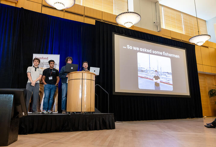 Students present at a lectern.