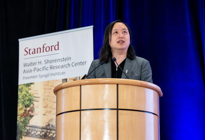 Audrey Tang delivers remarks at a lectern.