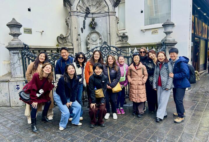 A group poses in front of a fountain in Brussels.