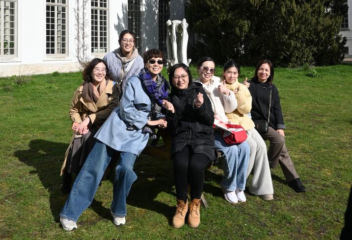People pose in front of a building in Leuven.