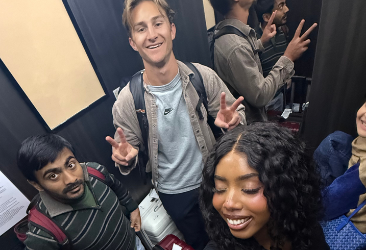 MIP Ashraf Sabkha, Humzah Khan, Kylie Jones, and Luke Anderson pose in an elevator in Tokyo, Japan.