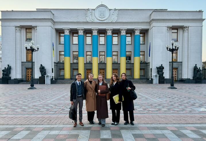 MIP students Gabriela Sommer, Haolie Jiang, Ren Jie Teoh, and Sophia Yushchenko with their hosts outside the main government buildings in Constitution Square in Kyiv, Ukraine.
