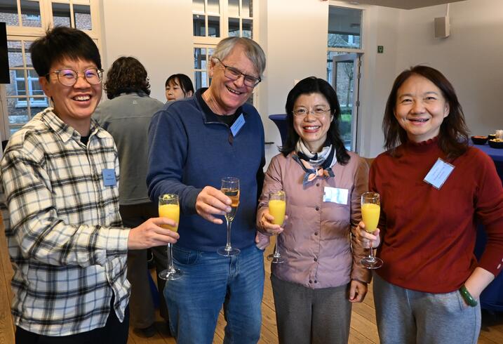 People pose with champagne glasse at a reception.