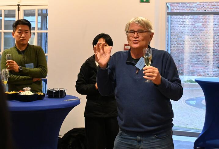 Scott Rozelle speaks with a glass of champagne in hand.