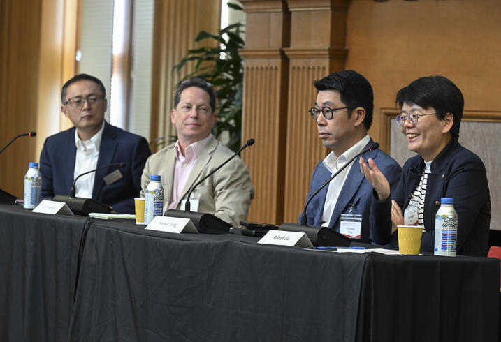 Ruixue speaks on a panel at a conference.