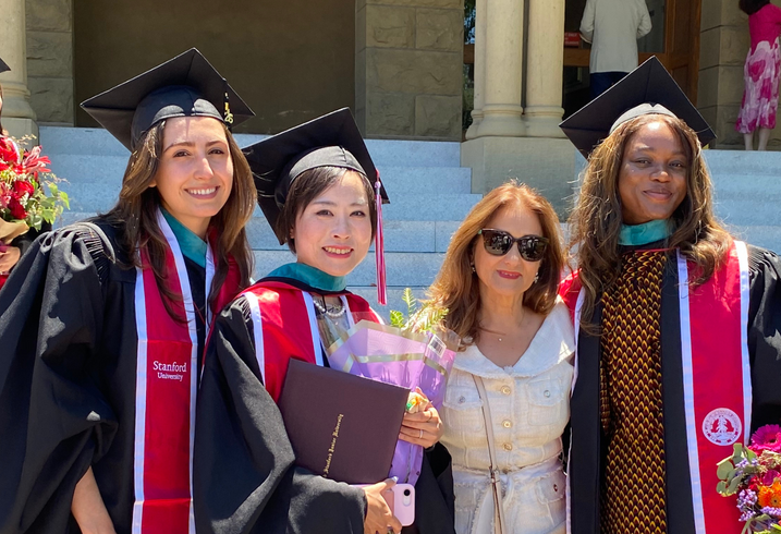 Graduates from the Ford Dorsey Master's in International Policy Class of 2026 pose together near the steps of Encina Hall at Stanford University.