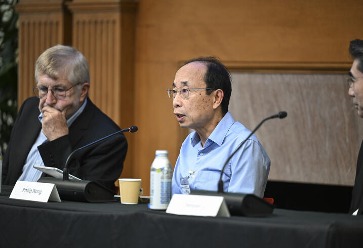 Philip Wang speaks on a panel at a conference.
