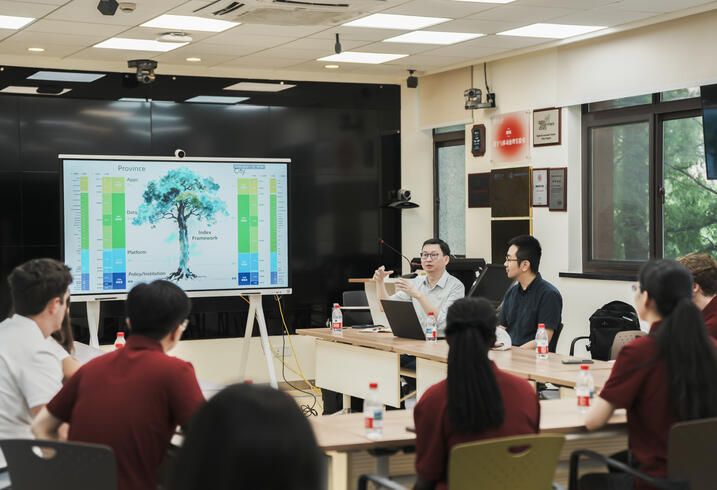 Students sit and listen to a presentation at Fudan University. 