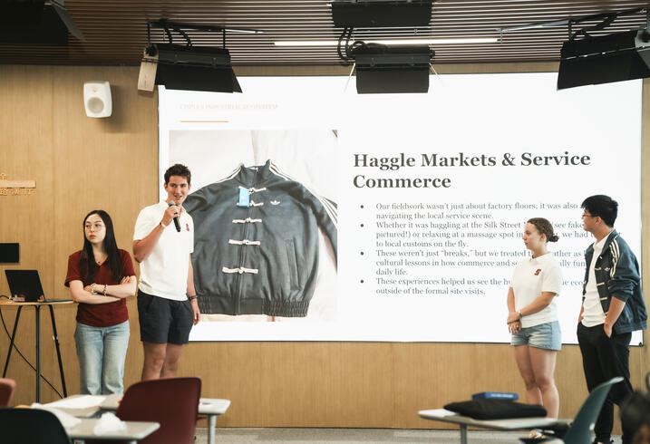Students present in front of a classroom.