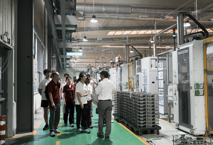 Students walk on the floor of the Shuanhuan factory.
