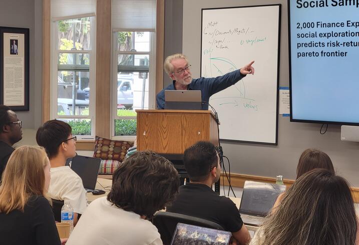 a presenter gesturing at a presentation