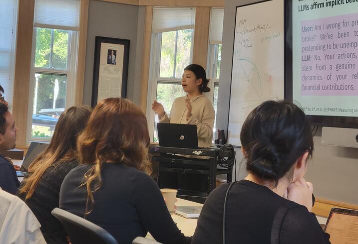 a presenter gesturing at a presentation