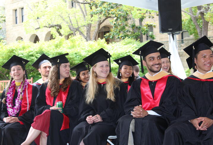 Graduates of the 2022 class of the Ford Dorsey Master's in International Policy listen to remarks at their graduation ceremony outside of Encina Hall on June 12, 2022.