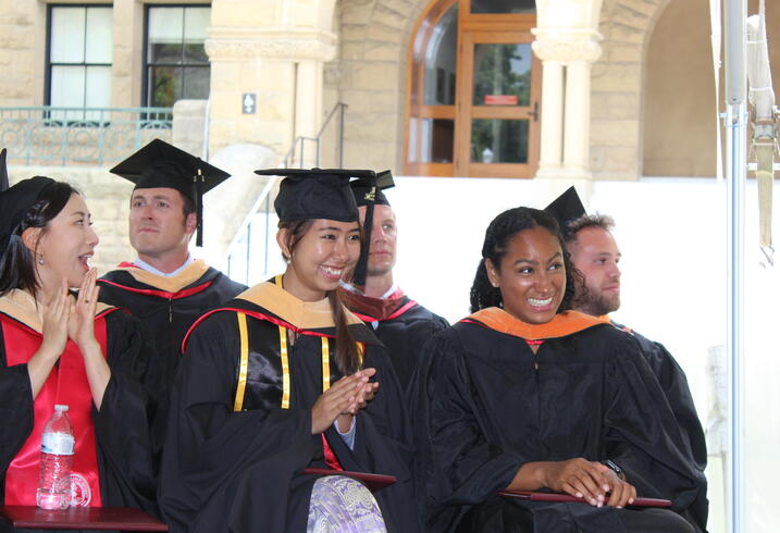 Graduates of the 2022 class of the Ford Dorsey Master's in International Policy listen to graudation remarks from FSI Director Michael McFaul outside of Encina Hall on June 12, 2022.