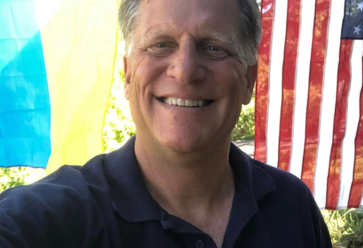 Michael McFaul stands in front of the Ukrainian and United States' flag at his home in California.