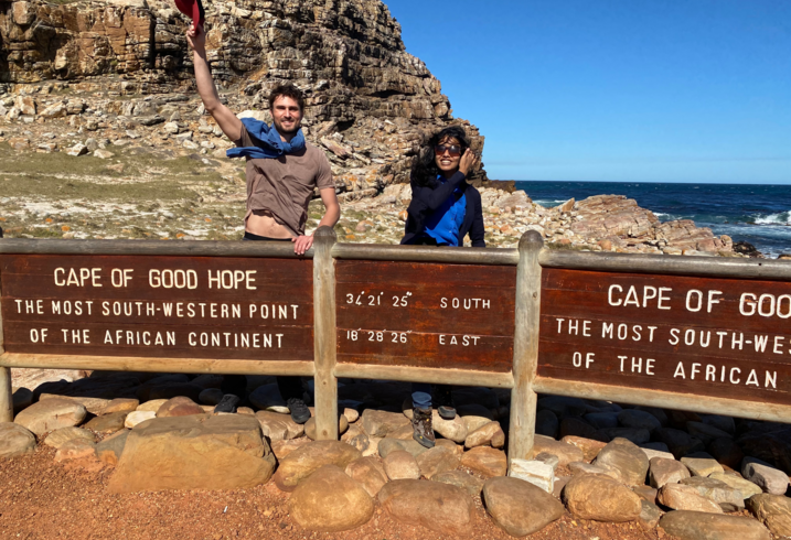 Eli MacKinnon and Janani Mohan pose at the Cape of Good Hope.