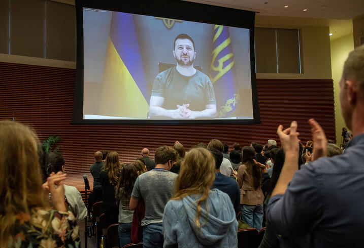 The audience applauds President Zelenskyy with a standing ovation during his remarks to the Stanford community in a live video address on March 27, 2022.