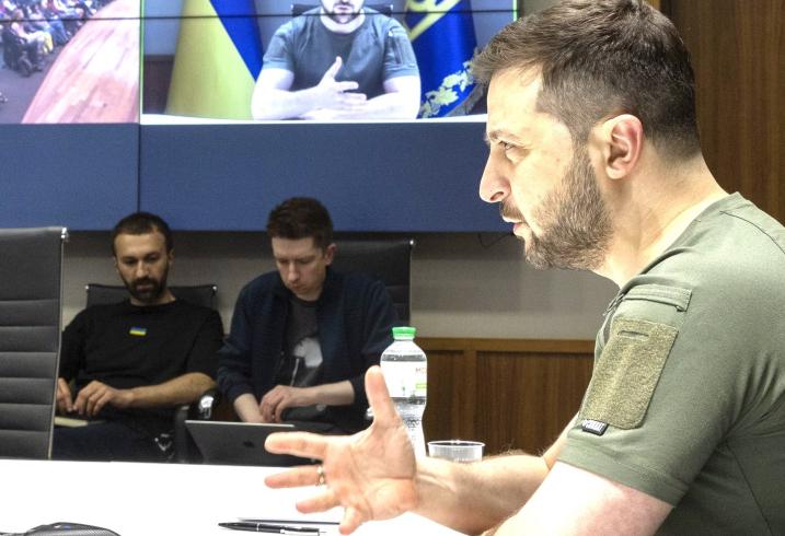 President Volodymyr Zelenskyy of Ukraine sits in his offices in Kyiv delivering a live video address to an audience at Stanford University.