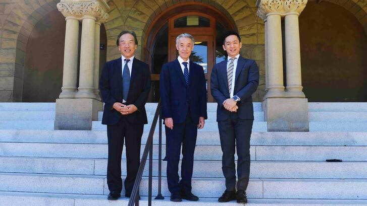 Japan's Ambassador to the US Shigeo Yamada, Consul General Yo Osumi, and Kiyoteru Tsutsui, posing on the front steps of Encina Hall, Stanford.