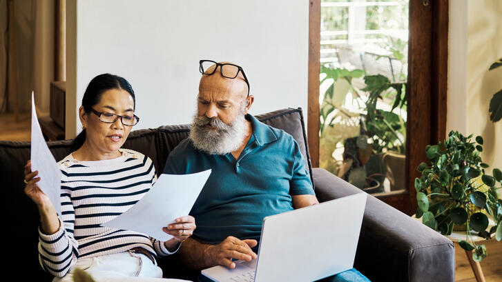 Couple looks at bills with concern