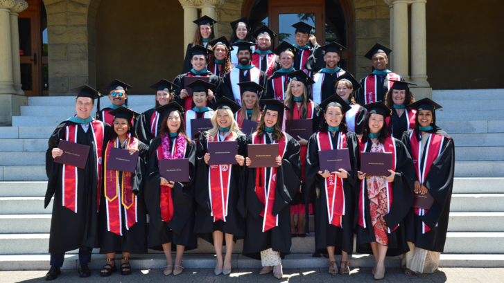 The graduating class of 2025 of the Ford Dorsey Master's in International Policy on the steps of Encina Hall at Stanford University.