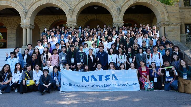 Participants at the NATSA 2025 conference post to the camera at the entrance to Encina Hall, Stanford University.