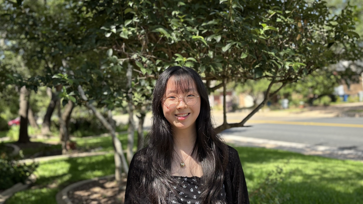a person standing in front of trees