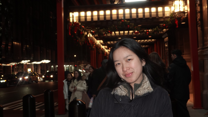 person standing in the street at night 