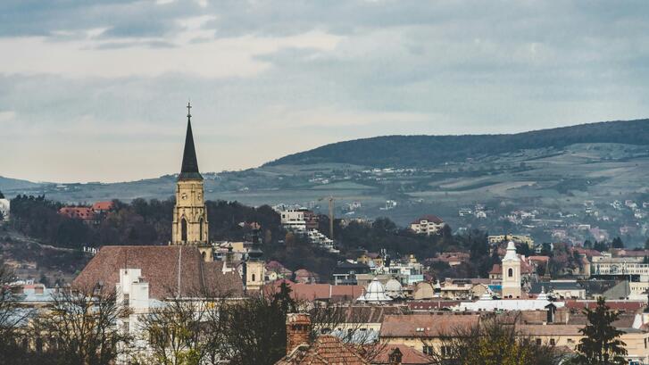 Brown and white concrete building under white clouds during daytime