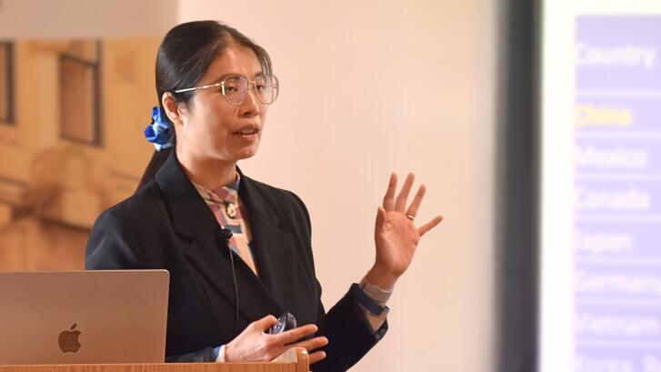Hsiao-Hui Lee presents at a lectern.
