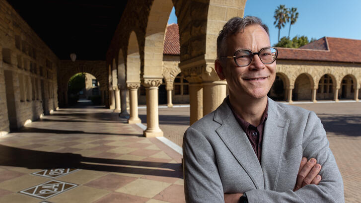 Colin H. Kahl under the arches of Stanford's main quad
