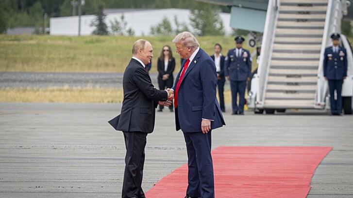 Trump and Putin shake hands