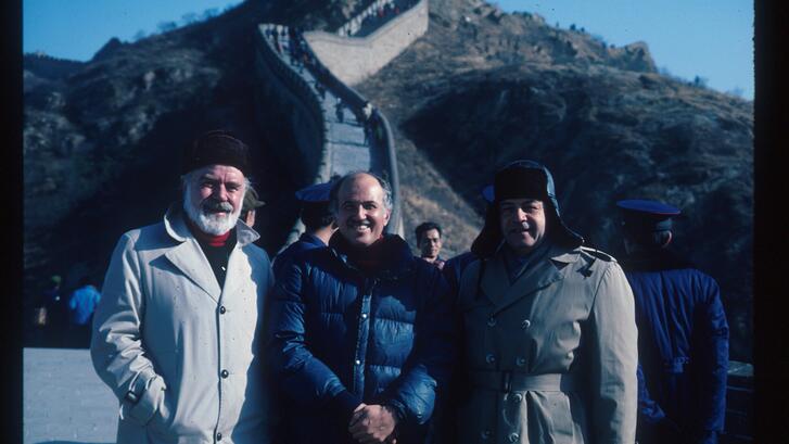 three people standing at the great wall in China