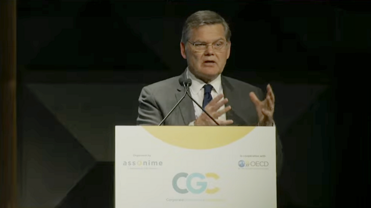 Curtis Milhaupt delivers a speech at a podium.