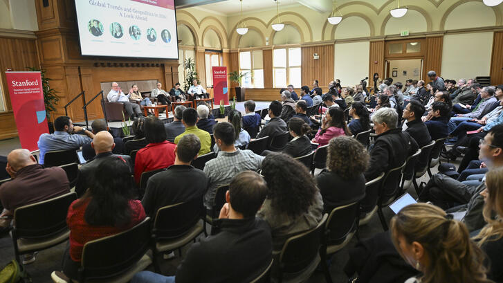 Large audience at Encina Hall listens to a discussion about global trends and geopolitics in 2026 by scholars at the Freeman Spogli Institute.
