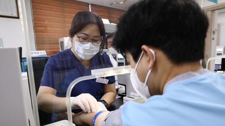 A teenager is given blood test during a physical examination in Seoul, South Korea.
