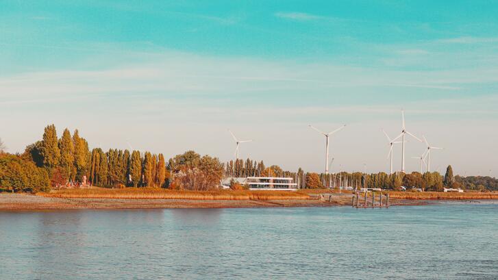 Antwerp, Belgium. A body of water with trees and a building in the background. Tayla Kohler / Unsplash