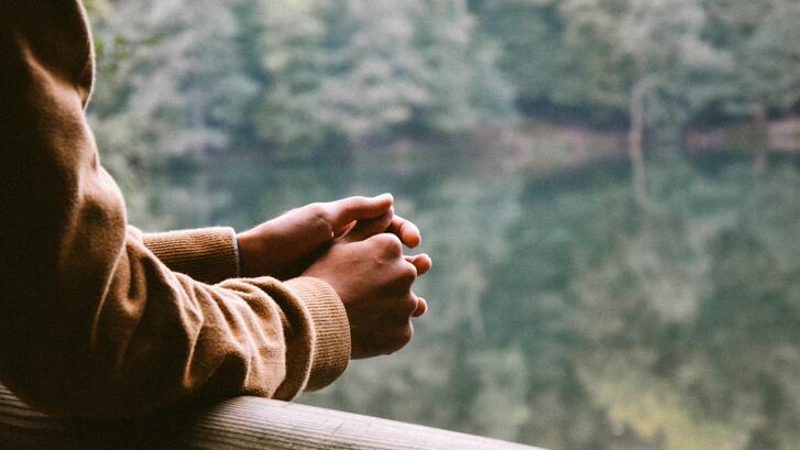 A photo of a person overlooking water