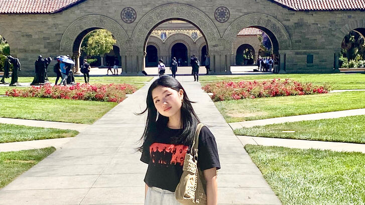 a student in front of Memorial Church during a summer program at Stanford University
