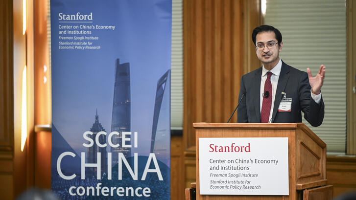 Rush Doshi speaks behind a podium at the SCCEI China Conference