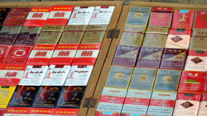 Rows of Chinese cigarette packs on display for sale.