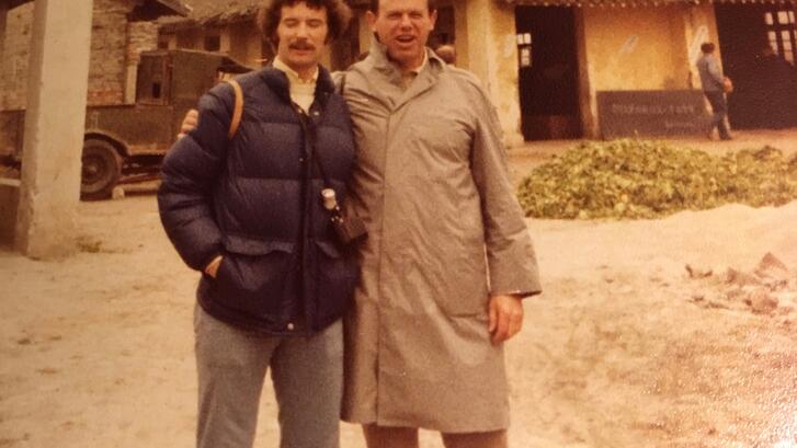 two men in jackets standing