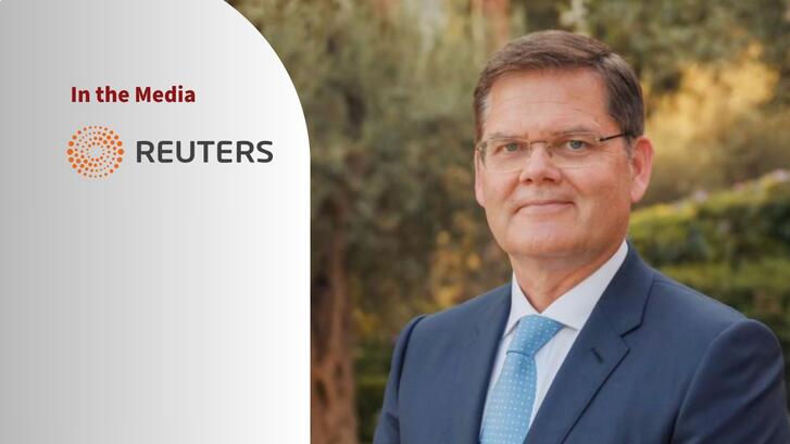 Portrait of Curtis Milhaupt and a logo of Retuers.