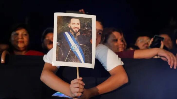 Holding an image of Salvadoran President Nayib Bukele, San Salvador, El Salvador, June 2025.
