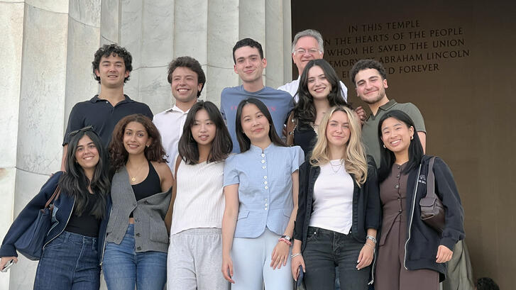 The Fisher Family Honors Program Class of 2026 poses at the Lincoln Memorial with faculty director Stephen Stedman.