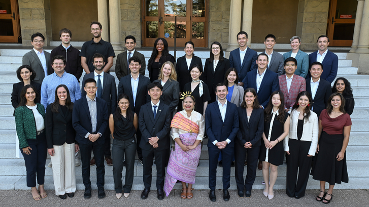 A group photo of the Class of 2028 of the Ford Dorsey Master's in International Policy on the front steps of Encina Hall at Stanford University.