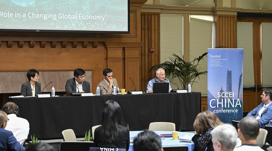 Panelists speak during a session at the 2025 SCCEI China Conference.