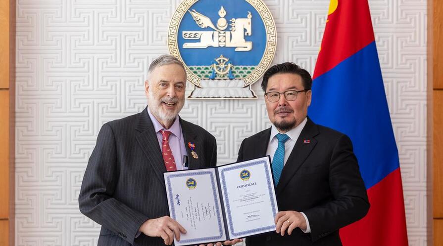 Professor James S. Fishkin was presented with the Medal of Friendship certificate by Zandanshatar Gombojav.